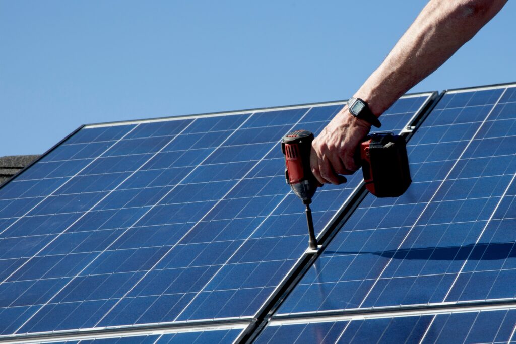 Future-Proofing Your Business with Solar Energy 2 Technician from Limitless Solar Solutions securing solar mounting system