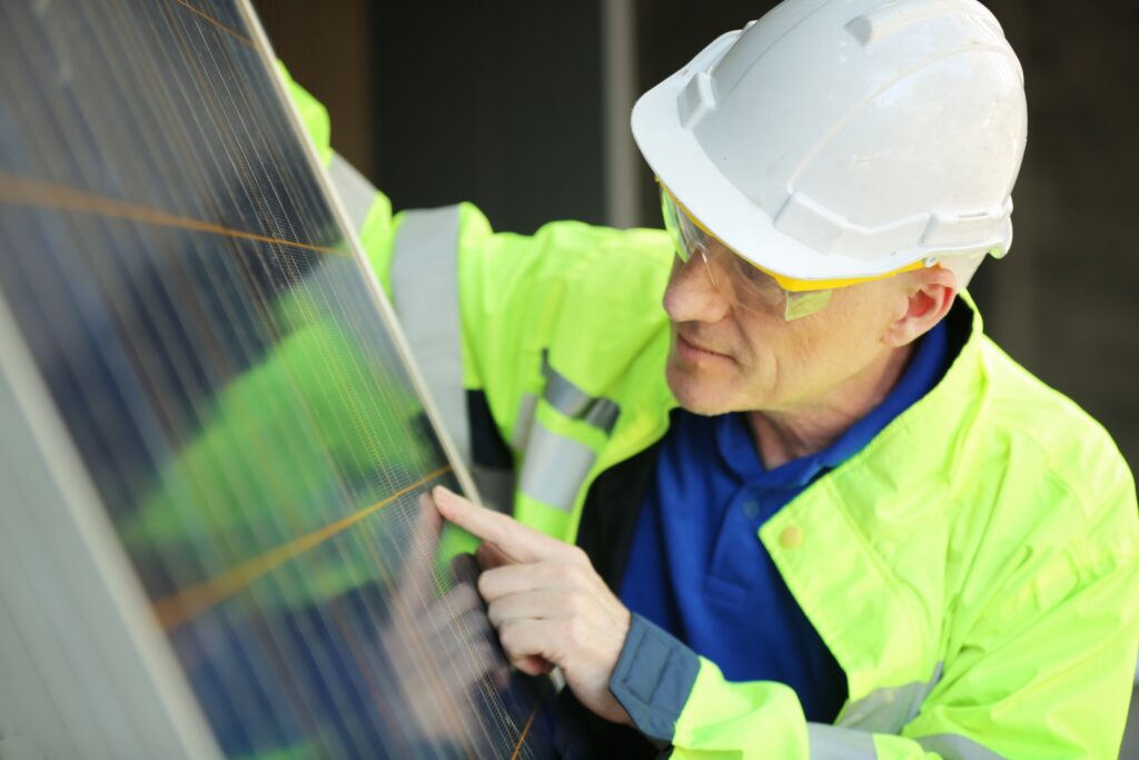 Professional solar panel maintenance technician from Limitless Solar Solutions inspecting and servicing a solar panel on a commercial installation in North Brisbane, demonstrating expert solar maintenance services across Brisbane and the Sunshine Coast.