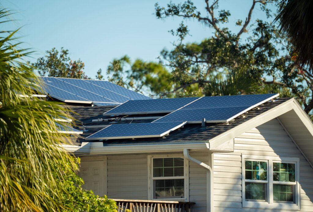 Rooftop solar panels surrounded by lush greenery on the Sunshine Coast, illustrating eco-friendly residential solar installations integrated with nature.