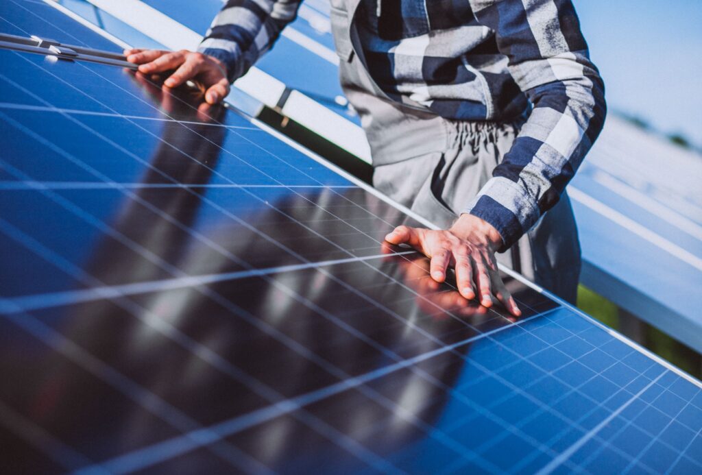Commercial Solar Systems Gympie: Maximising Business ROI in the Wide Bay 5 Close-up of a technician inspecting and maintaining solar panels to ensure optimal performance and safety.